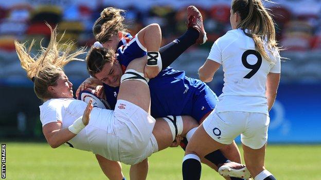 England's Poppy Cleall is tackled by a French player