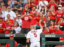 Albert Pujols gives Nelly a high five after smashing a homerun